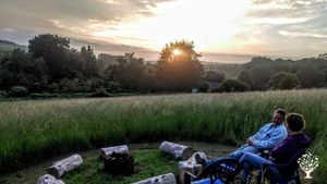Evening at the campfire on the hill looking down on the orchard.