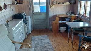 The cottage includes a living room and two bedrooms, a small kitchenette, and two or three beds