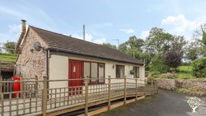 A small site with a forest garden, orchard, vegetable and flower gardens and grassland with trees.