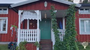 A family vegetable garden and an old house under the Baltic midnight sun