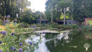 Symbiotic homestead with permaculture garden at the edge of a forest.