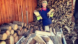 WWOOFer, Michael, stacking firewood (fall, 2022)