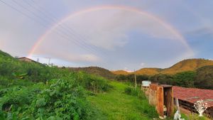 Rainbows like this are not uncommon during the rainy season, though the trees are taller now!