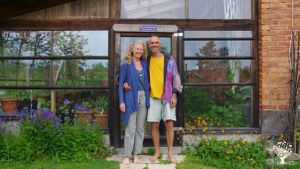 Hosts in front of greenhouse