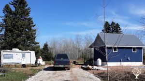 A view as you drive in. You would be staying in the RV and I live in the blue cabin. 