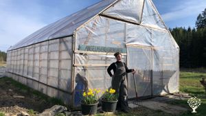 Angela standing infront of our 6m x 12m greenhouse. We also have a  larger 7m x 20m greenhouse. 